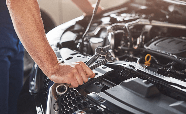 A mechanic replacing old car parts with high-quality OEM parts