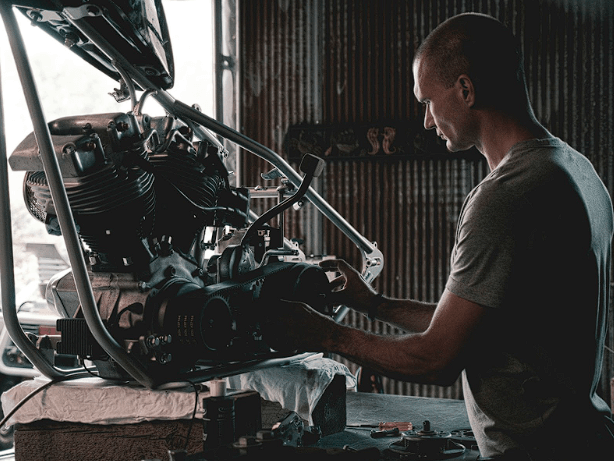 A mechanic inspecting used car parts for quality